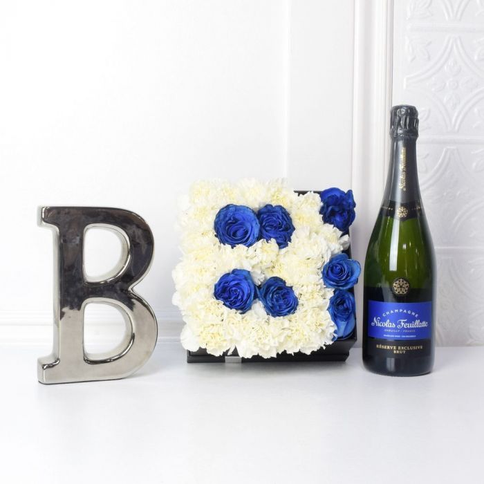 Celebrate Baby Boy with Letter B Flower Box and Champagne – gift basket with flower box, white and blue flowers and bottle of champagne